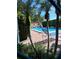 Community pool area featuring lounge chairs, palm trees, and a view of the clubhouse at 2411 Quail Ct, Bradenton, FL 34209