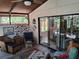 Bright sunroom with cozy seating, decorative accents, and views of the outdoors at 2411 Quail Ct, Bradenton, FL 34209