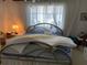 Bedroom showcasing a metal bed frame and view of the window with sheer curtains at 2617 Riverbluff Pkwy # V151, Sarasota, FL 34231