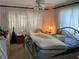 Bright bedroom with large window, ceiling fan, and ornate metal bed frame at 2617 Riverbluff Pkwy # V151, Sarasota, FL 34231
