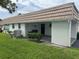 Exterior side view with grass and a stone pillar at 2617 Riverbluff Pkwy # V151, Sarasota, FL 34231