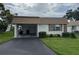 Charming single-story home with a covered carport, well-maintained lawn, and tidy landscaping at 2617 Riverbluff Pkwy # V151, Sarasota, FL 34231