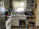 Functional kitchen with a double sink, tiled backsplash, ample cabinet space, and natural light from the window at 2617 Riverbluff Pkwy # V151, Sarasota, FL 34231