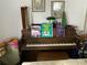 Living room featuring a vintage piano and musical instruments on display at 2617 Riverbluff Pkwy # V151, Sarasota, FL 34231