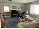 Cozy living room featuring plush seating, a large window for natural light, and neutral carpeting at 2617 Riverbluff Pkwy # V151, Sarasota, FL 34231