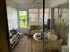 Enclosed sun room featuring outdoor furniture and a view to the outside at 2617 Riverbluff Pkwy # V151, Sarasota, FL 34231