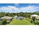 A beautiful aerial view of single Gathering homes surrounded by trees showing privacy and space in a tranquil, green neighborhood at 2692 Pretzel Ln, North Port, FL 34286
