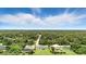 Expansive aerial view of homes nestled amongst the trees with blue skies above, showcasing the tranquility of the neighborhood at 2692 Pretzel Ln, North Port, FL 34286