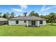 Home's backyard featuring covered patio, green lawn, and privacy at 2692 Pretzel Ln, North Port, FL 34286