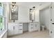 Modern bathroom with double sink vanity, granite countertop and stylish lighting fixtures at 2692 Pretzel Ln, North Port, FL 34286