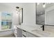 Bright bathroom features double sinks, black faucets, modern lighting, and sleek white countertop at 2692 Pretzel Ln, North Port, FL 34286