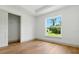Bright bedroom with wood flooring, large window, closet and fresh paint at 2692 Pretzel Ln, North Port, FL 34286