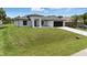 Well-maintained single-Gathering home featuring green lawn and two-car garage at 2692 Pretzel Ln, North Port, FL 34286