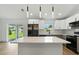 Bright, open-concept kitchen with a large island and stainless steel appliances at 2692 Pretzel Ln, North Port, FL 34286