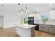 Modern kitchen featuring white cabinets, a center island, and stainless steel appliances at 2692 Pretzel Ln, North Port, FL 34286