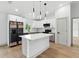 Beautiful kitchen featuring an island with modern lighting and stainless steel appliances at 2692 Pretzel Ln, North Port, FL 34286