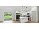 Modern kitchen with white cabinets, a center island, stainless steel appliances, and sliding glass doors at 2692 Pretzel Ln, North Port, FL 34286
