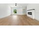 A bright living room featuring hardwood floors, a ceiling fan, and an electric fireplace at 2692 Pretzel Ln, North Port, FL 34286