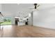 Spacious living room with hardwood floors and a view to the modern kitchen at 2692 Pretzel Ln, North Port, FL 34286