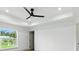 Spacious primary bedroom featuring a tray ceiling, ceiling fan, and luxury vinyl flooring at 2692 Pretzel Ln, North Port, FL 34286
