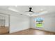 Well lit main bedroom with tray ceiling, ceiling fan, and luxury vinyl flooring at 2692 Pretzel Ln, North Port, FL 34286