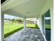 Covered patio with gray pavers and view of the backyard at 2692 Pretzel Ln, North Port, FL 34286
