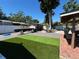 The backyard has green artificial grass and an outdoor dining area at 2804 11Th Street E Ct, Bradenton, FL 34208