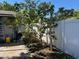 Backyard featuring a tree, white fence, and outdoor shed, offering a private outdoor space at 2804 11Th Street E Ct, Bradenton, FL 34208