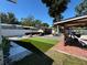 Backyard with artificial grass, outdoor dining and entertainment area at 2804 11Th Street E Ct, Bradenton, FL 34208