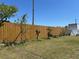 Backyard showcasing a tall wooden fence, some growing plants, and lawn at 2804 11Th Street E Ct, Bradenton, FL 34208