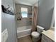 Bathroom features a tub with tile surround, a window, and gray walls at 2804 11Th Street E Ct, Bradenton, FL 34208