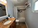 Bathroom with granite vanity, a tub with tile surround, and neutral paint at 2804 11Th Street E Ct, Bradenton, FL 34208