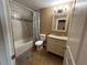 Well-lit bathroom with a shower-tub combo, a vanity with storage, a decorative mirror, and neutral wall colors at 2804 11Th Street E Ct, Bradenton, FL 34208