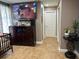 Bedroom featuring a dresser with a TV above, adjacent to a doorway and hallway, with neutral paint and decor at 2804 11Th Street E Ct, Bradenton, FL 34208