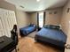 Shared bedroom featuring two twin beds, a desk, and a closet, with blue bedding and neutral-colored walls at 2804 11Th Street E Ct, Bradenton, FL 34208