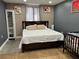 Cozy bedroom with neutral tones, a large bed, and natural light from the window with light-filtering curtains at 2804 11Th Street E Ct, Bradenton, FL 34208