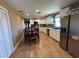 The kitchen features white cabinets, tile floors and stainless steel appliances at 2804 11Th Street E Ct, Bradenton, FL 34208