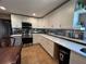 The kitchen features white cabinets, quartz countertop and stainless steel appliances at 2804 11Th Street E Ct, Bradenton, FL 34208