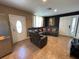 Comfortable living room featuring a leather sectional sofa, a modern TV, and neutral-colored walls with tiled flooring at 2804 11Th Street E Ct, Bradenton, FL 34208