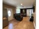 Inviting living room with a leather sectional sofa, tiled flooring, and a view of the front door and a side door at 2804 11Th Street E Ct, Bradenton, FL 34208