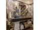 Chic bathroom featuring unique wallpaper, dark countertops, and ample storage space for toiletries at 3401 54Th W Dr # 201, Bradenton, FL 34210