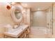 Bright bathroom featuring a tub, glass shower and a circular mirror with a modern sink at 3401 54Th W Dr # 201, Bradenton, FL 34210
