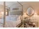 Bright bedroom features a modern four-poster bed with desk and decorative seashell art at 3401 54Th W Dr # 201, Bradenton, FL 34210