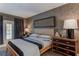 Bedroom featuring a woven bed frame, accent wall and dark wood dresser at 3401 54Th W Dr # 201, Bradenton, FL 34210