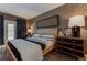 Bedroom featuring a woven bed frame, accent wall and dark wood dresser at 3401 54Th W Dr # 201, Bradenton, FL 34210