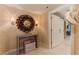 Inviting hallway with decorative mirror, table, and a barn door, enhancing the home's charm at 3401 54Th W Dr # 201, Bradenton, FL 34210
