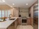 Bright kitchen features stainless appliances, unique cabinets, and island seating for casual dining at 3401 54Th W Dr # 201, Bradenton, FL 34210