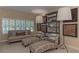 Bright and airy living room featuring stylish seating, decorative shelving, and plantation shutters at 3401 54Th W Dr # 201, Bradenton, FL 34210