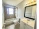 Bright bathroom featuring a tub and shower, vanity, and tiled floors at 3526 Southern W Pkwy, Bradenton, FL 34205