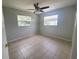 Neutral bedroom featuring tile flooring, a ceiling fan, and ample natural light at 3526 Southern W Pkwy, Bradenton, FL 34205